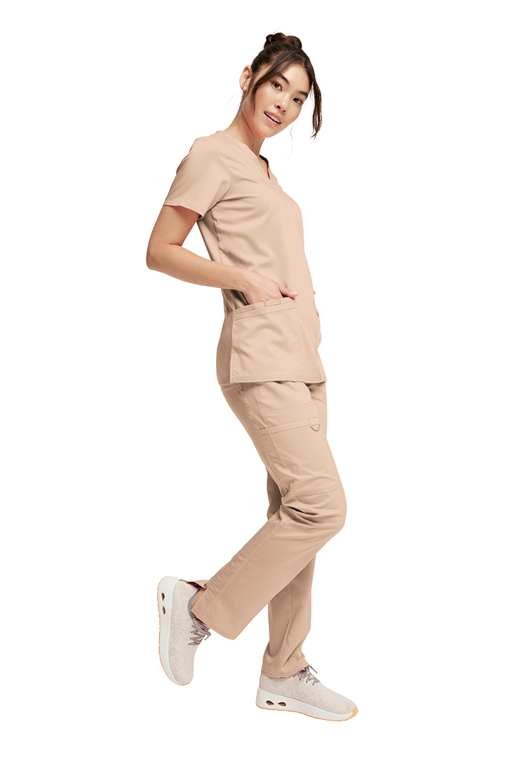 Woman wearing a beige Cherokee Revolution scrub se, WW620 Top and WW120 Pants 